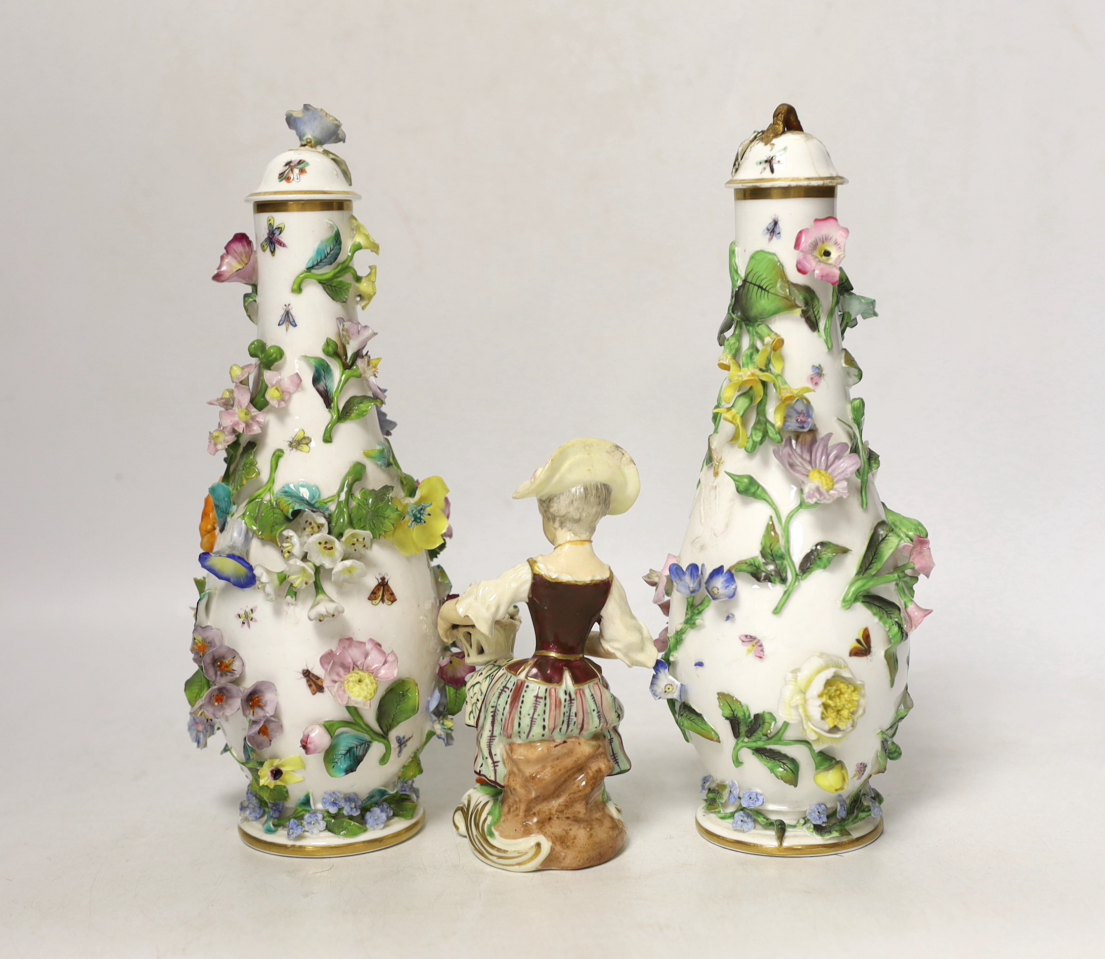 A pair of Minton flower encrusted bottle vases and covers, c.1835, and a Minton seated figure of a flower girl, c.1830-5, pseudo Meissen mark, bottle vases and covers, 22.5cm high